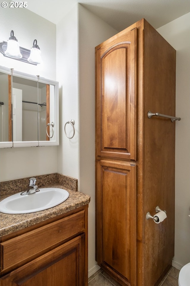 bathroom with tile patterned floors and vanity