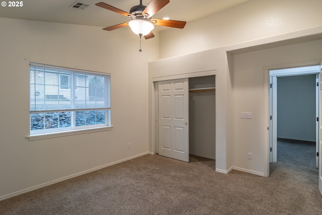 unfurnished bedroom with carpet flooring, ceiling fan, and a closet