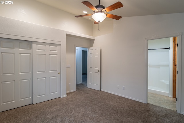 unfurnished bedroom with ceiling fan, light colored carpet, and a closet