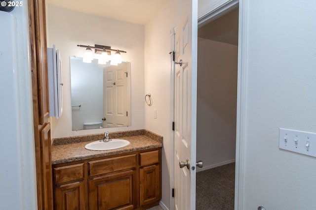 bathroom featuring vanity and toilet