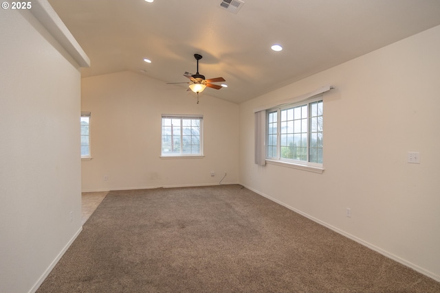 carpeted spare room with ceiling fan and lofted ceiling