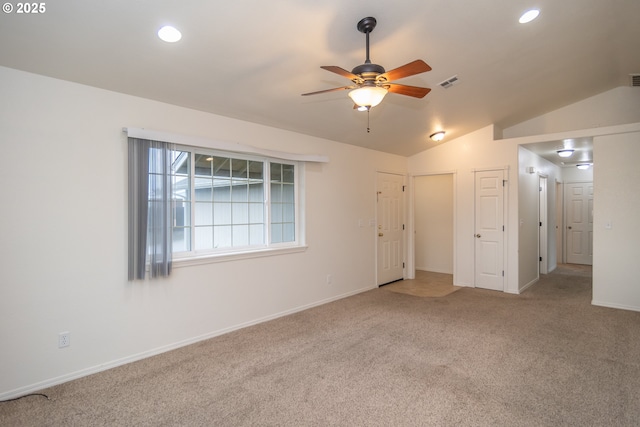 unfurnished room featuring ceiling fan, carpet floors, and vaulted ceiling