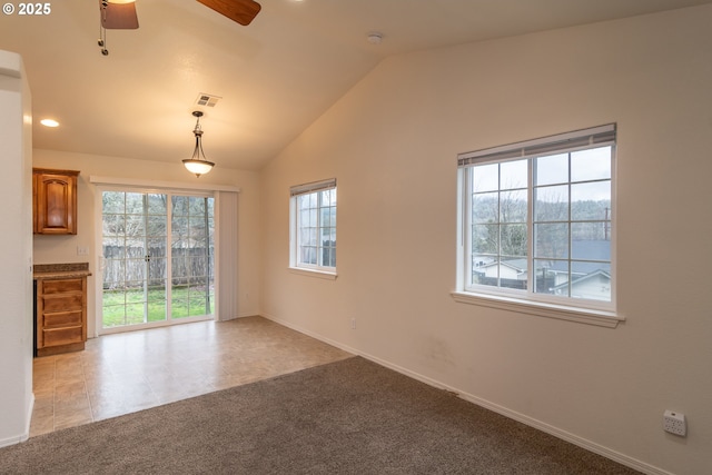 carpeted empty room with ceiling fan and lofted ceiling