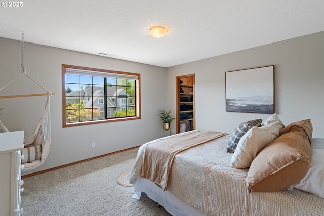 carpeted bedroom with visible vents and baseboards