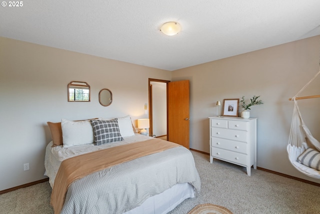 bedroom with baseboards and light colored carpet