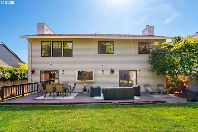 rear view of property with an outdoor hangout area, fence, a chimney, and a lawn