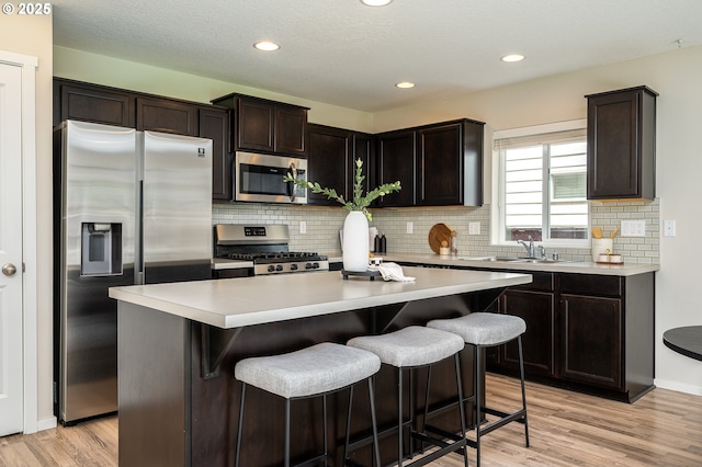 505 NE 138th Pl, Vancouver, WA 98684 - kitchen with appliances with stainless steel finishes, backsplash, a center island, light countertops, and recessed lighting