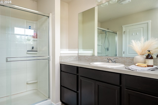 505 NE 138th Pl, Vancouver, WA 98684 - full bathroom featuring a shower stall, vanity, and backsplash