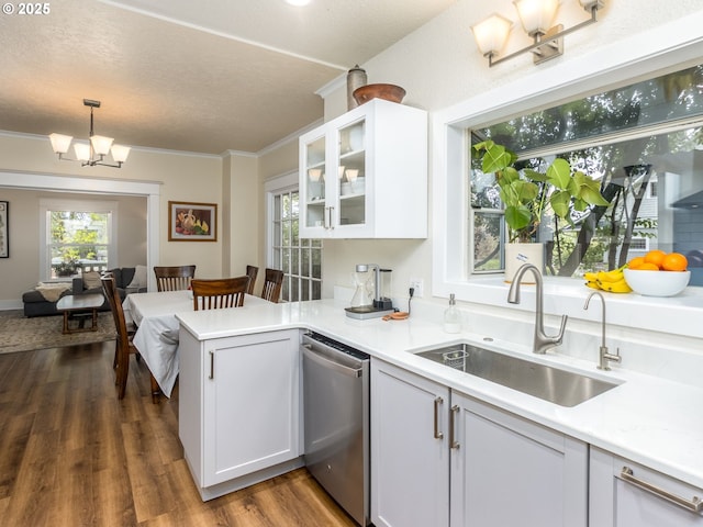 2820 SE 47th Ave, Portland, OR 97206 - kitchen with a peninsula, light countertops, a chandelier, a sink, and dishwasher