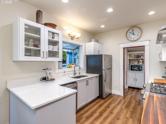 2820 SE 47th Ave, Portland, OR 97206 - kitchen featuring appliances with stainless steel finishes, a sink, light countertops, white cabinets, and glass insert cabinets