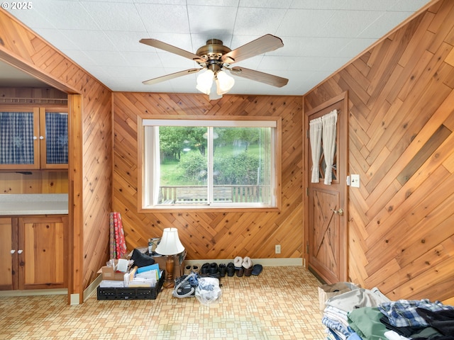 94031 Green Acres Ln, Coos Bay, OR 97420 - spare room with wood walls, a ceiling fan, and baseboards