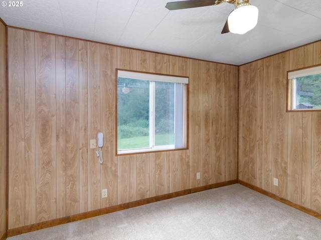 94031 Green Acres Ln, Coos Bay, OR 97420 - carpeted spare room with wooden walls, baseboards, and ceiling fan