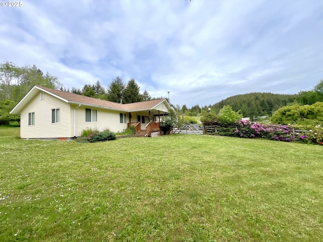 94031 Green Acres Ln, Coos Bay, OR 97420 - view of grassy yard featuring covered porch