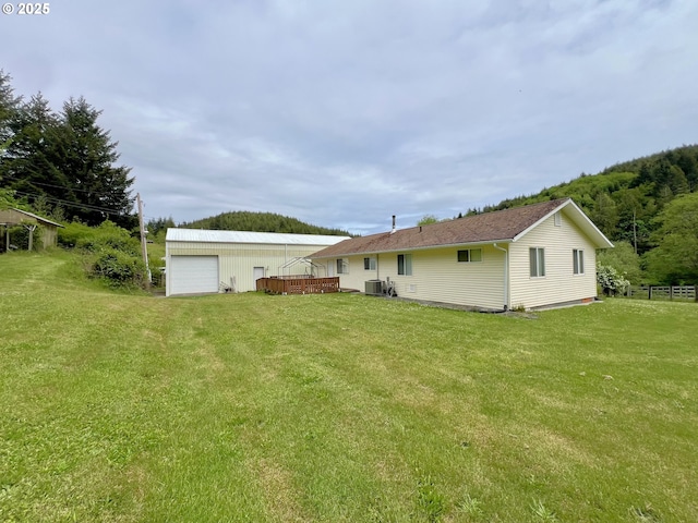 94031 Green Acres Ln, Coos Bay, OR 97420 - rear view of property with central air condition unit, a garage, an outbuilding, and a wooden deck