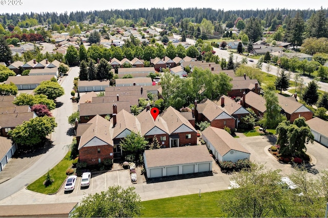 bird's eye view featuring a forest view and a residential view
