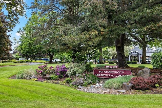 community / neighborhood sign with a lawn