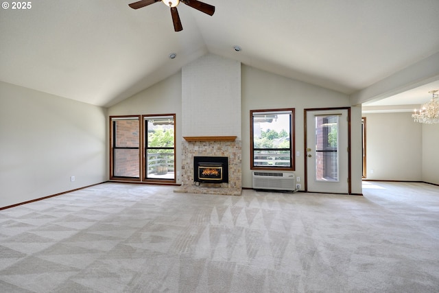 unfurnished living room with a wall mounted air conditioner, high vaulted ceiling, light colored carpet, and ceiling fan with notable chandelier