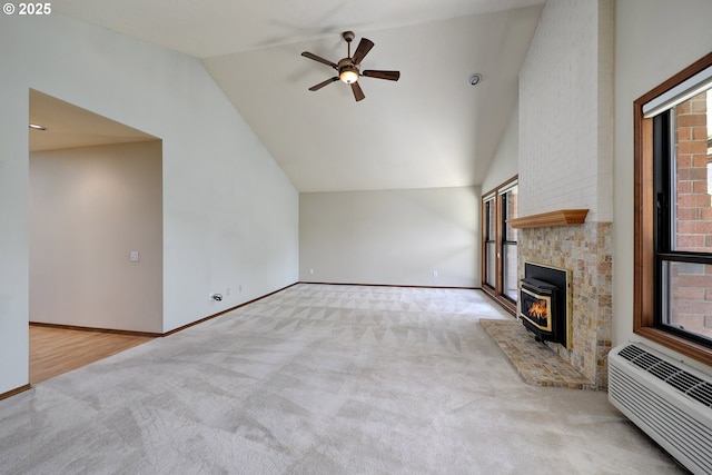 unfurnished living room featuring high vaulted ceiling, an AC wall unit, carpet floors, a ceiling fan, and baseboards