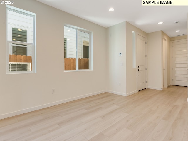 spare room with recessed lighting, wood finished floors, and baseboards