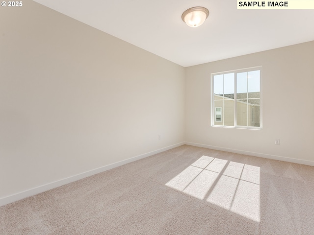 unfurnished room featuring baseboards and light colored carpet