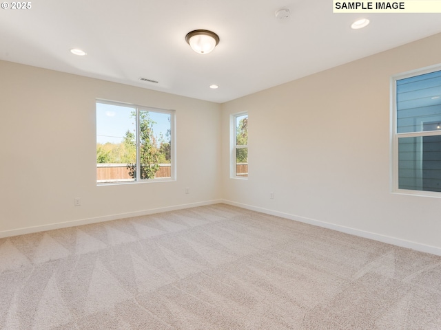 unfurnished room with light carpet, baseboards, visible vents, and recessed lighting