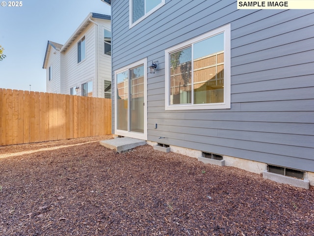 rear view of house featuring fence