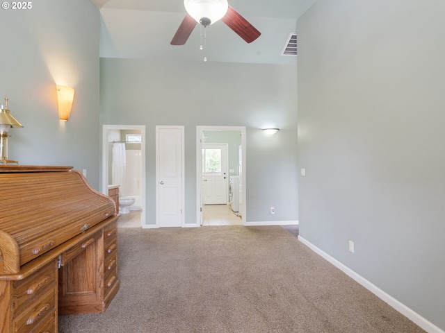 14829 S Quail Crest Ln, Oregon City, OR 97045 - unfurnished bedroom with connected bathroom, a towering ceiling, and light colored carpet