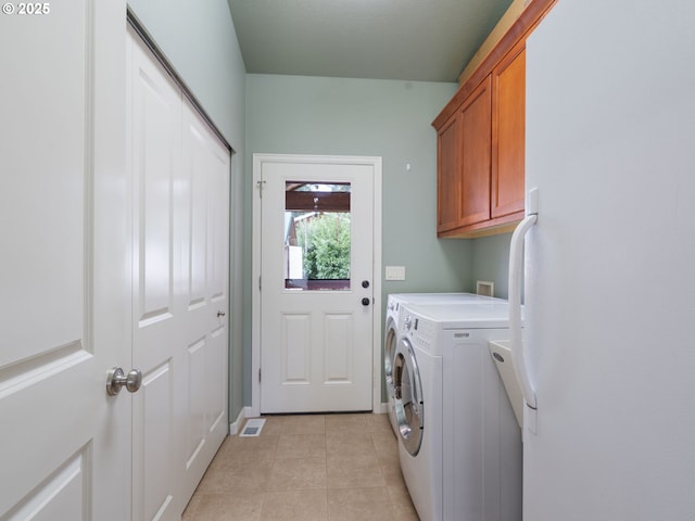 14829 S Quail Crest Ln, Oregon City, OR 97045 - laundry area featuring cabinet space, washing machine and clothes dryer, and light tile patterned floors
