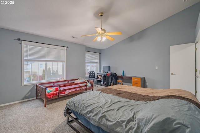 carpeted bedroom featuring lofted ceiling, a ceiling fan, visible vents, and baseboards