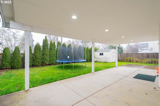 view of patio / terrace featuring an outbuilding, a fenced backyard, and a storage shed