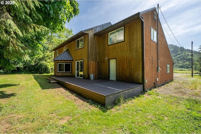 7980 Kilchis River Rd, Tillamook, OR 97141 - rear view of property with a deck, a yard, and a standing seam roof
