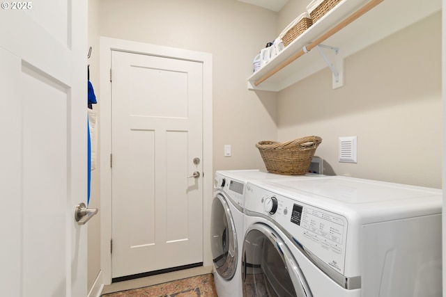 clothes washing area with washing machine and clothes dryer