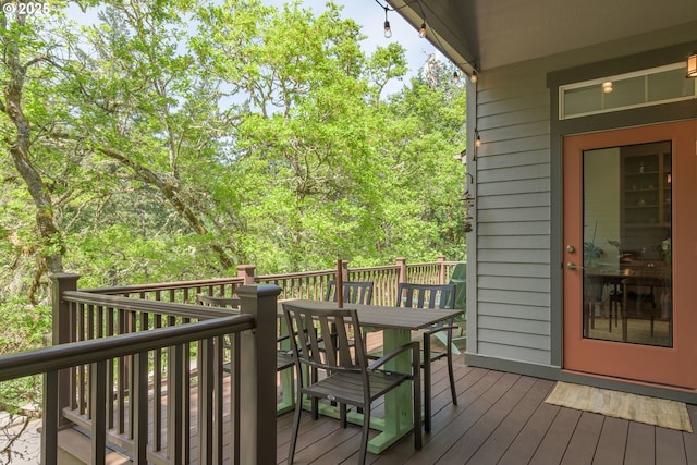 deck with outdoor dining area