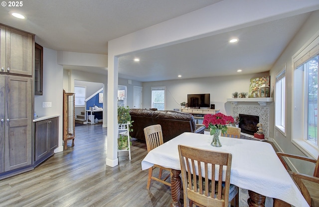 dining space with a fireplace and light hardwood / wood-style floors