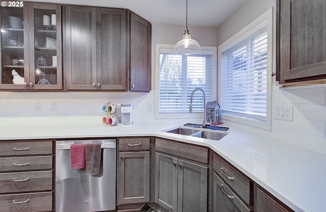 kitchen with sink, decorative light fixtures, dark brown cabinets, and stainless steel dishwasher