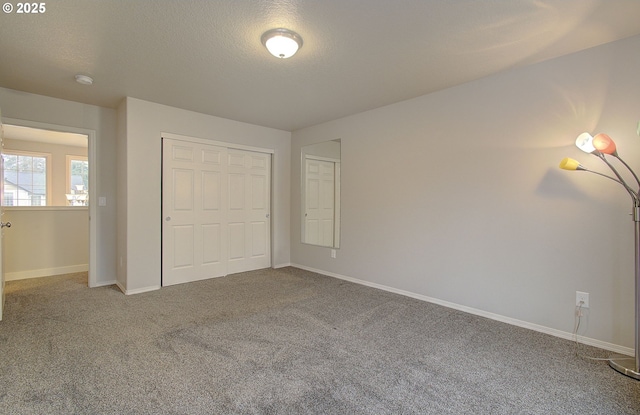 unfurnished bedroom with a closet, a textured ceiling, and carpet flooring