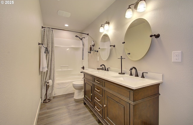 full bathroom with hardwood / wood-style flooring, vanity, toilet, and shower / bath combo with shower curtain