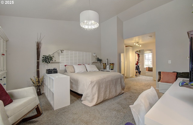 bedroom featuring light carpet and a chandelier