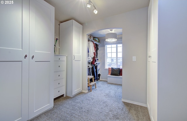 hallway featuring light colored carpet