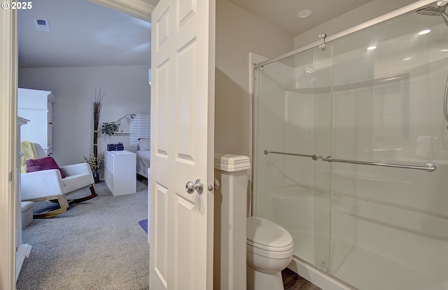 bathroom with an enclosed shower and toilet