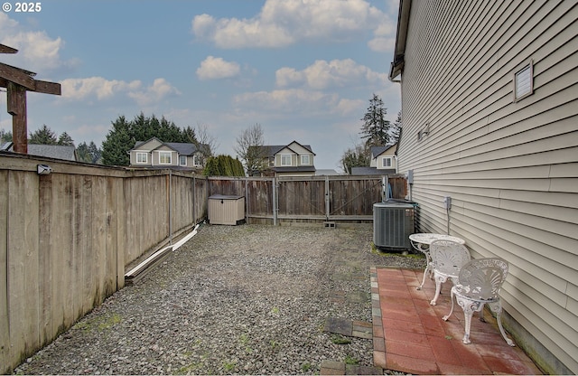 view of yard with cooling unit and a patio