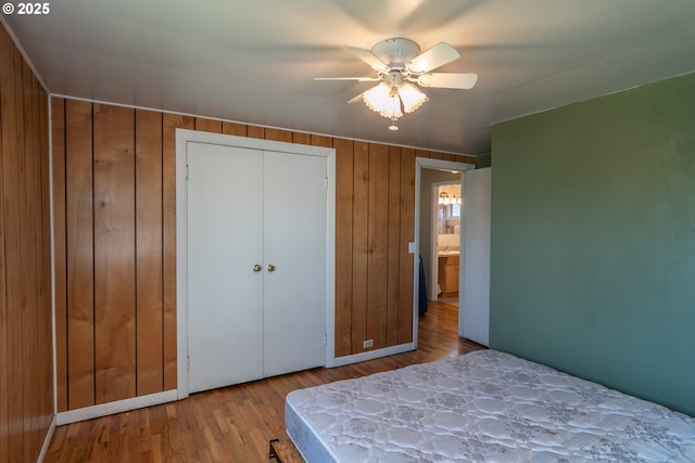 164 Pippin Ave, Roseburg, OR 97471 - bedroom with ceiling fan, baseboards, wood finished floors, and wooden walls