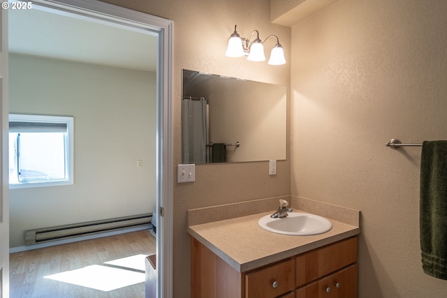 164 Pippin Ave, Roseburg, OR 97471 - bathroom with a baseboard heating unit, wood finished floors, and vanity