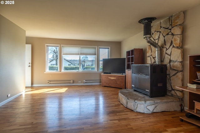 164 Pippin Ave, Roseburg, OR 97471 - unfurnished living room featuring baseboard heating, wood finished floors, and a wood stove
