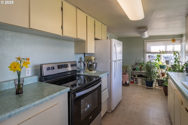 164 Pippin Ave, Roseburg, OR 97471 - kitchen with stainless steel electric range oven, light countertops, and cream cabinets