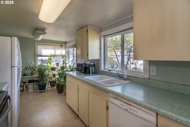 164 Pippin Ave, Roseburg, OR 97471 - kitchen with light tile patterned flooring, light countertops, a sink, and white appliances