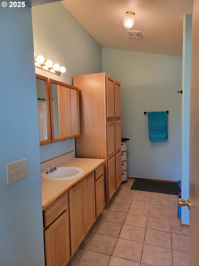 full bathroom with visible vents, tile patterned floors, and vanity