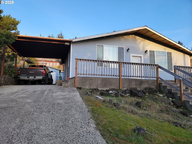 view of front of home featuring an attached carport and driveway