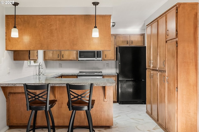 kitchen with stainless steel appliances, a sink, a peninsula, decorative backsplash, and light marble finish flooring
