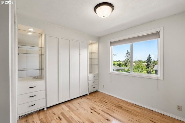 unfurnished bedroom with light wood-style floors and baseboards